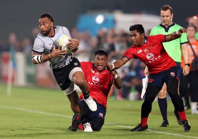 The UAE's Sakiusa Naisau is tackled during their Asian Rugby Championship match against Malaysia in Dubai. The UAE is ranked in the world's top 50. Chris Whiteoak / The National