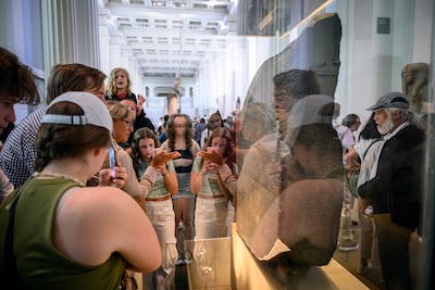 Visitors gather around the Rosetta Stone at the British Museum, where it has been displayed since 1802. Getty Images