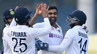 India's Ravichandran Ashwin, centre, celebrates with teammates after taking the wicket of New Zealand batsman Tom Blundell. AFP