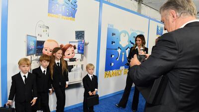 Actor Alec Baldwin takes a picture of his children as wife Hilaria Baldwin looks on, at the premiere of 'The Boss Baby: Family Business'. AFP