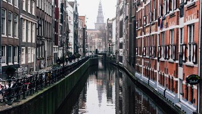 Amsterdam's new tourism tax charges visitors a per night, per person fee on top of an existing percentage fee.