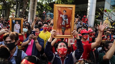 People hold up images of Myanmar's de-facto leader Aung San Suu Kyi at a protest outside Maynmar's embassy in Bangkok, Thailand. Getty Images