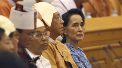 Aung San Suu Kyi and Htin Kyaw, second from right, attend a ceremony to take oaths in parliament in Naypyitaw, Myanmar. Aung Shine Oo / AP