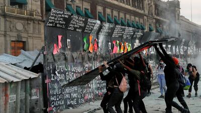 People try to take down the fences placed outside the National Palace during a protest on International Women's Day, in Mexico City, Mexico. Reuters