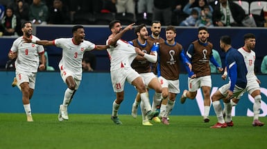 Nizar Al Rashdan, centre, celebrates with teammates after scoring against Saudi Arabia in the Arab Cup semi-final. AFP