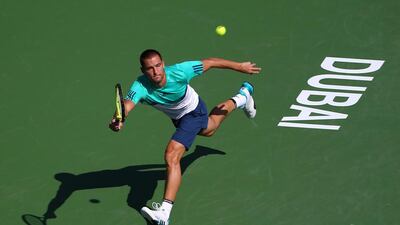 Russian Mikhail Youzhny returns the ball to Tunisian Malek Jaziri during their ATP tennis match on the first round of the Dubai Duty Free Tennis Championships on February 22, 2016. AFP / MARWAN NAAMANI