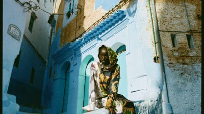 Dress with detachable hood, Dh6,224, Salvatore Ferragamo. Boots, Dh5,900, Stuart Weitzman