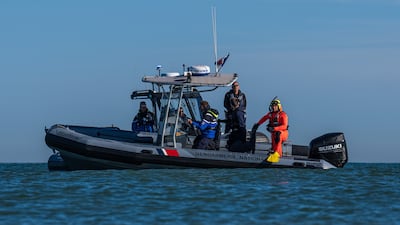 A French police officer looks on as migrants to try and board a dinghy to cross the English Channel. Getty Images