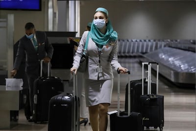 A flight attendant wearing a face mask as at Manila's International Airport in the Philippines. Photo: AP