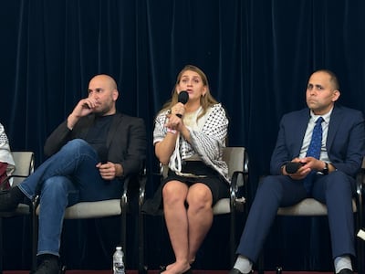 Layla Elabed, centre, speaks alongside fellow activists Omar Badar, left, and Hani Almadhoum on the DNC sidelines at Chicago's Rainbow Push Coalition headquarters. The National