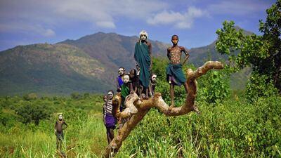 (FILES) This file photo taken on September 24, 2016 shows children from the Suri tribe posing in Ethiopia's southern Omo Valley region near Kibbish. More than 1.1 billion people worldwide officially don't exist -- going about their daily lives without proof of identity. The issue leaves a significant fraction of the global population deprived of health and education services, international organizations lament. Among these "invisible people" -- many of whom live primarily in Africa and Asia -- more than one-third are children susceptible to violence whose births have not been registered, the World Bank's "Identification for Development" (ID4D) program recently warned. / AFP PHOTO / CARL DE SOUZA