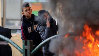 Palestinians burn tires during clashes with Israeli troops in the city of Hebron in the occupied West Bank. EPA