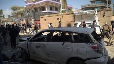 Afghan residents inspect the site of a suicide bombing outside a voter registration centre in Kabul on April 22, 2018. Shah Marai / AFP
