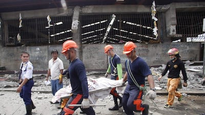 Rescue members recover the body of a vendor killed after an earthquake hit Pasil market in Cebu City, Central Philippines. Reuters / Stringer