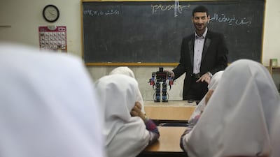 Akbar Rezaie, 27, attended private robotics classes and learnt to develop and assemble customised humanoid robots. Vahid Salemi / AP Photo