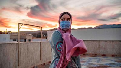 A Moroccan worker stands at the terrace of a building in the Moroccan city of Fnideq overlooking the Spanish enclave of Ceuta. AFP