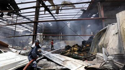 Yemeni firefighters extinguish the flames at the site of an alleged Saudi-led airstrike in Sana on August 9, 2016. Yahya Arhab/EPA