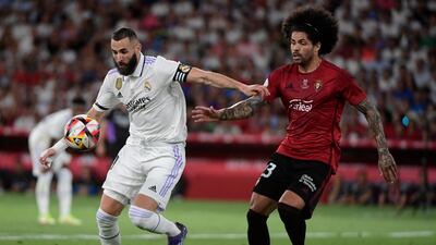 Real Madrid forward Karim Benzema fights for the ball with Osasuna defender Aridane. AFP