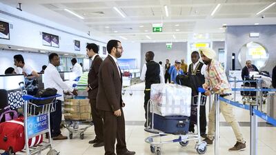 Passengers queue while waiting to depart from terminal one of Abu Dhabi International Airport. Christopher Pike / The National