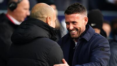 Luton Town manager Rob Edwards greets Manchester City manager Pep Guardiola before the match. PA
