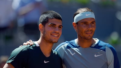 Carlos Alcaraz, left, with Rafael Nadal before their Madrid Open quarter-final clash on May 6, 2022. AFP