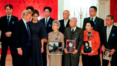 US President Donald Trump and First Lady Melania meet families of Japanese citizens abducted by North Korea during mr Trump's official visit to Tokyo. In the cente of the front row is Sakie Yokota, mother of Megumi Yokota who was abducted by North Korean agents in Japan when she was 13. Megumi's twin brothers Takuya and Tetsuya Yokota are to the left and behind Sakie. Kimimasa Mayama / AFP