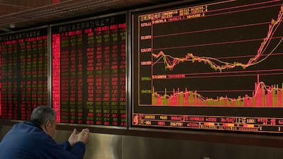 An investor monitors stock prices at a brokerage in Beijing. The coronavirus pandemic and collapse of oil prices have dealt a double blow to capital flows to emerging market countries. AP