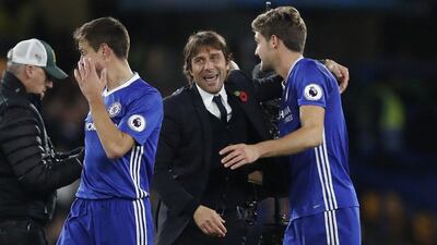 Chelsea manager Antonio Conte, centre, congratulates Cesar Azpilicueta, left, and Marcos Alonso, right, after the English Premier League match between Chelsea and Everton at Stamford Bridge in London, Saturday, November 5, 2016. Chelsea won the match 5-0. Kirsty Wigglesworth / AP Photo