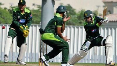 AD201011127005-Pakistani crickUmar Akmal, right, plays a shot as his brother and wicketkeeper Adnan Akmal, left, watches during a practice game in Dubai yesterday.