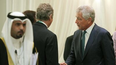 Chuck Hagel, the US defence secretary, right, is greeted upon arrival to address the International Institute of Strategic Studies conference in Manama on Saturday. Hasan Jamali / AP Photo
