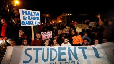 Students hold signs and a banner outside the Government Palace following the resignation of government ministers. Reuters