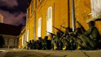 Under the cover of darkness, rebel soldiers loyal to opposition leader Andry Rajoelina approach the downtown presidential office in Antananarivo.