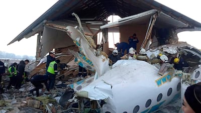 In this handout photo provided by the Emergency Situations Ministry of the Republic of Kazakhstan, police and rescuers work on the site of a plane crash near Almaty International Airport. AP