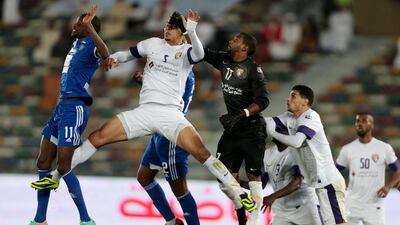 Al Ain's goalkeeper Khalid Essa, in black, tries to clear the ball against Al Nasr during a President's Cup semi-final match at Zayed Sports City in Abu Dhabi. Christopher Pike / The National