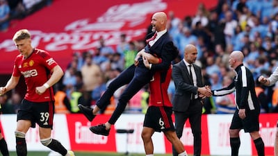 Manchester United manager Erik ten Hag celebrates with Lisandro Martinez after winning the Emirates FA Cup. PA