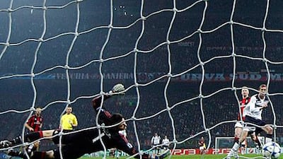 Tottenham Hotspur's Peter Crouch scores past AC Milan goalkeeper Marco Amelia.