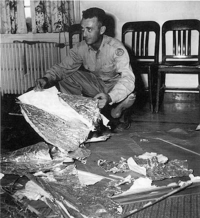 A military officer with debris recovered the alleged site of a 1947 UFO crash in Roswell, New Mexico. Getty Images
