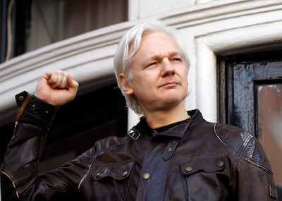 WikiLeaks founder Julian Assange greets supporters outside the Ecuadorian embassy in London. AP