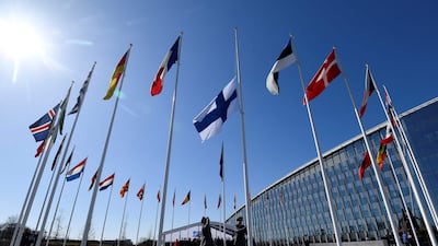 The Finnish flag is raised to join those of other Nato member states in Brussels on Tuesday. AFP