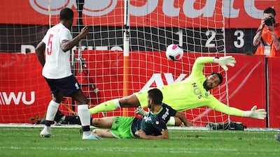 Liverpool's Georginio Wijnaldum, left, scores a goal. AFP
