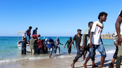 Migrants rescued by the Libyan coastguard come ashore in Tripoli on July 26, 2019. Scores more are believed to have drowned when their boat capsized the previous day. Reuters