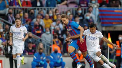 Barcelona striker Luuk De Jong battles for the ball with Real Madrid midfielder Casemiro. AFP