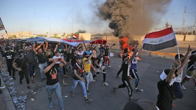 Iraqi protesters take part in a demonstration against state corruption, failing public services, and unemployment, in Baghdad. AFP