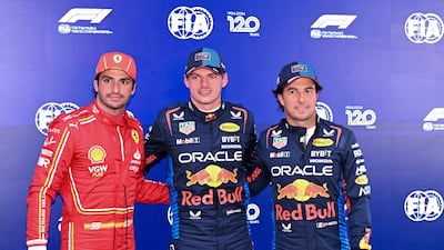 Red Bull Racing's Max Verstappen, centre, alongside second-placed qualifier Ferrari's Carlos Sainz Jr, left, and Red Bull driver Sergio Perez. AFP