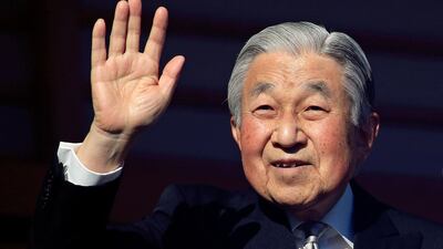 Japan's Emperor Akihito waves to well-wishers through bullet-proof glass during his New Year's public appearance at the Imperial Palace in central Tokyo, Japan. EPA