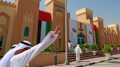 Voters arrive at Sharjah Cultural and Chess Club on Monday as early polling booths opened for the FNC elections. Victor Besa for The National