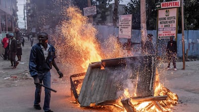 An Azimio La Umoja Party supporter protests in front of a burning barricade near in the informal settlement of Mathare in Nairobi. AFP
