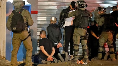 Israeli forces detain a group of Palestinian Israelis in the mixed Arab-Jewish city of Lod on May 13, 2021, during clashes between Jewish far-right extremists and Arab residents. AFP