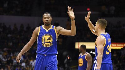 Golden State Warriors forward Kevin Durant, left, high-fives Stephen Curry during a pre-season game. Denis Poroy / AP Photo / October 19, 2016
