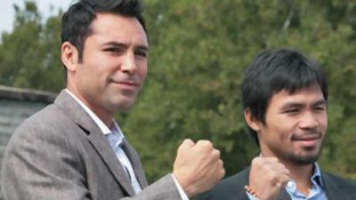 Oscar De La Hoya, left, and Manny Pacquiao pose for photographers after a news conference at Liberty Island in New York, on October 1, 2008.